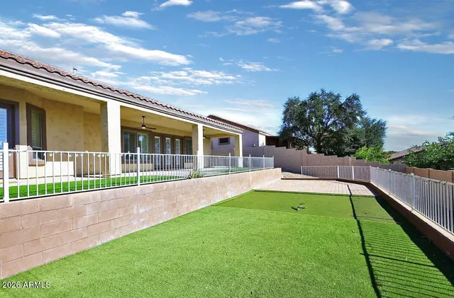 a view of an house with backyard and porch