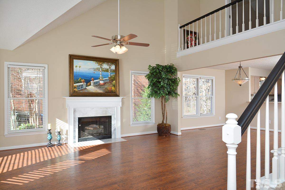 4517 Emmit Drive Raleigh, NC 27604 - Photo 2 of 25 a view of a livingroom with furniture wooden floor fireplace and windows