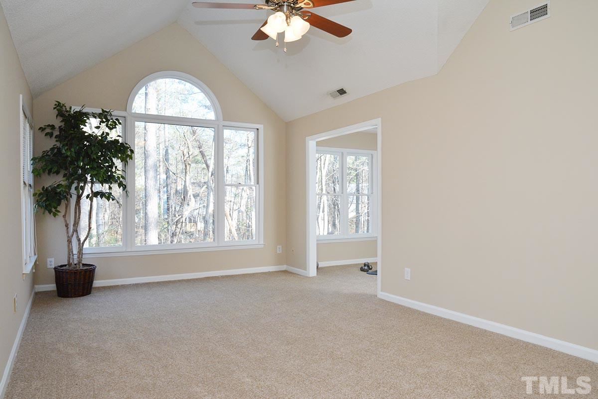 4517 Emmit Drive Raleigh, NC 27604 - Photo 11 of 25 an empty room with a window and a chandelier