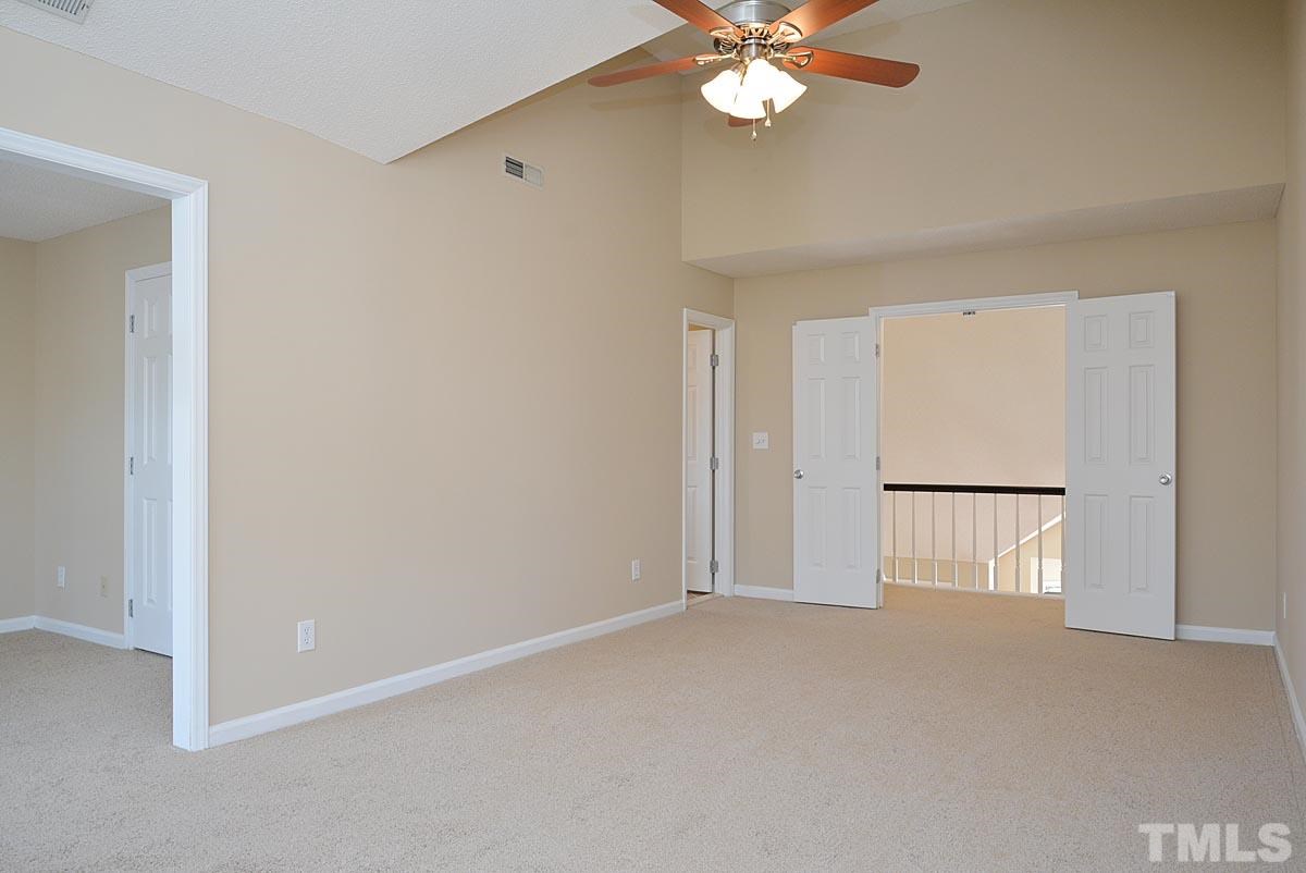 4517 Emmit Drive Raleigh, NC 27604 - Photo 12 of 25 an empty room with a chandelier fan