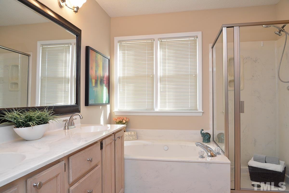 4517 Emmit Drive Raleigh, NC 27604 - Photo 13 of 25 a bathroom with a tub sink and mirror