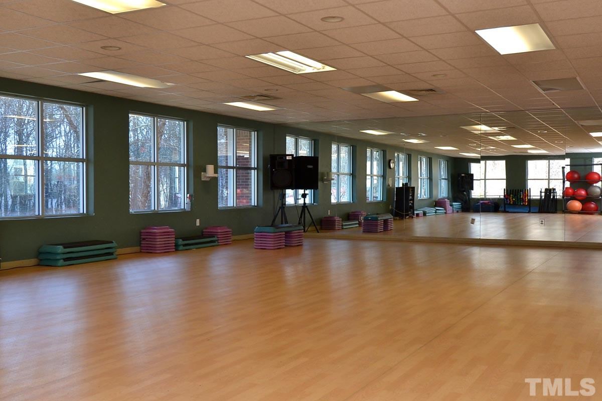4517 Emmit Drive Raleigh, NC 27604 - Photo 24 of 25 a view of a room with gym equipment and large windows