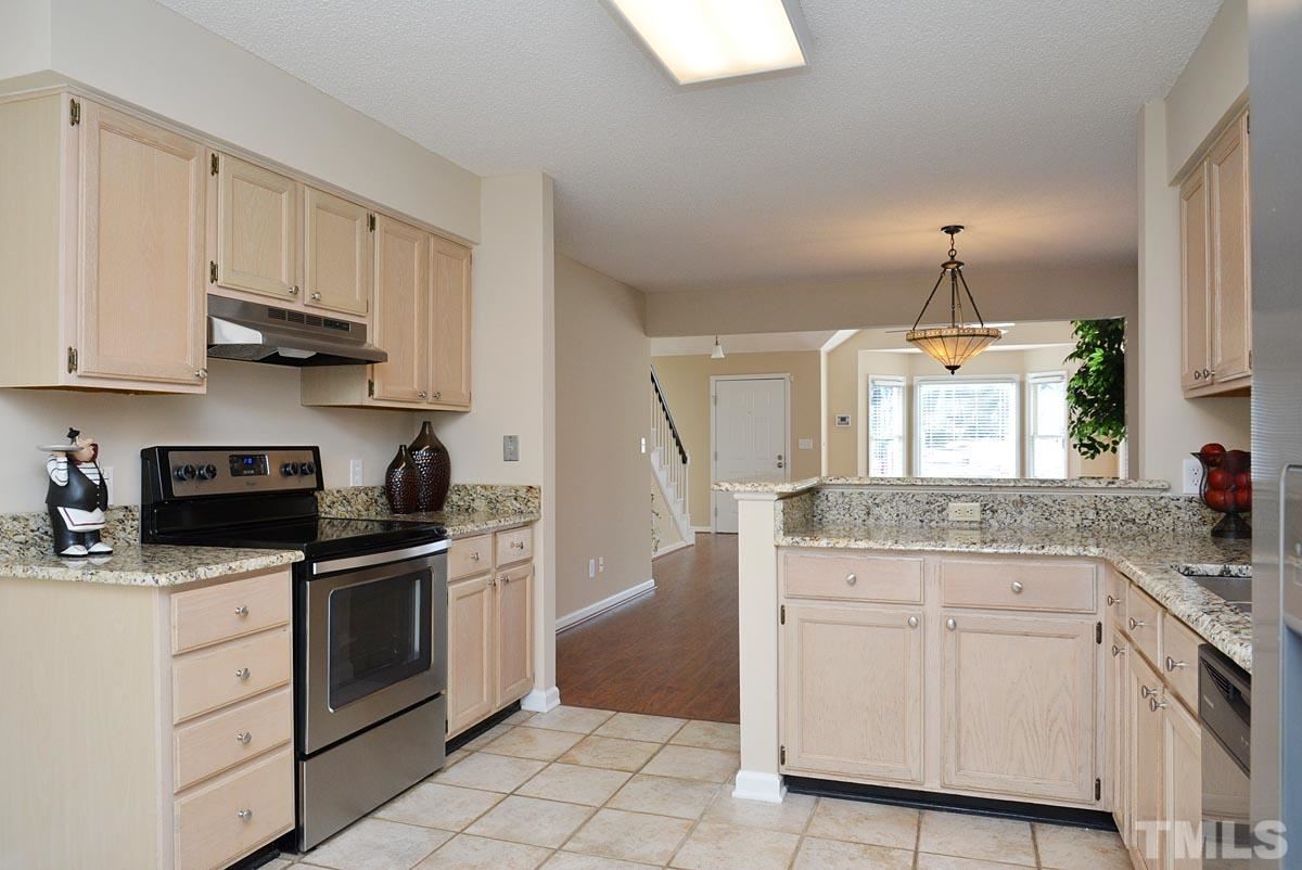 4517 Emmit Drive Raleigh, NC 27604 - Photo 6 of 25 a kitchen with white cabinets and appliances