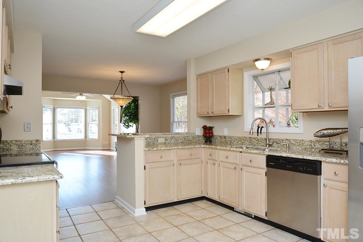 4517 Emmit Drive Raleigh, NC 27604 - Photo 7 of 25 a kitchen with a sink stove and cabinets