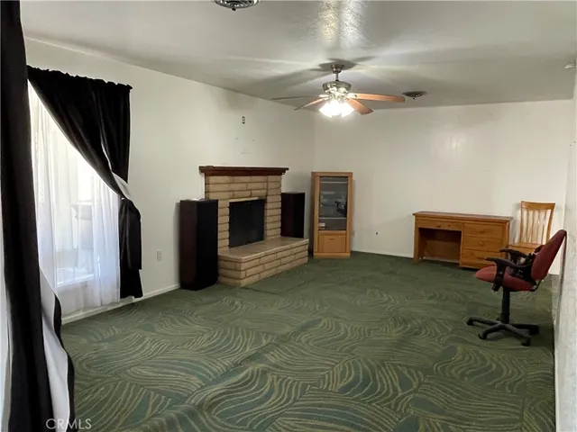 a view of a livingroom with a fireplace and furniture