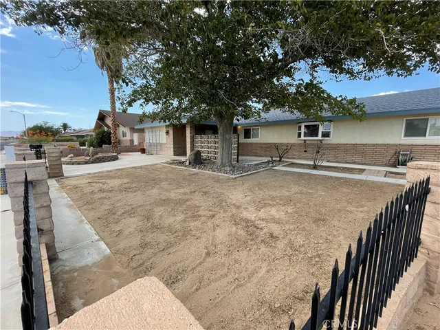a backyard of a house with table and chairs
