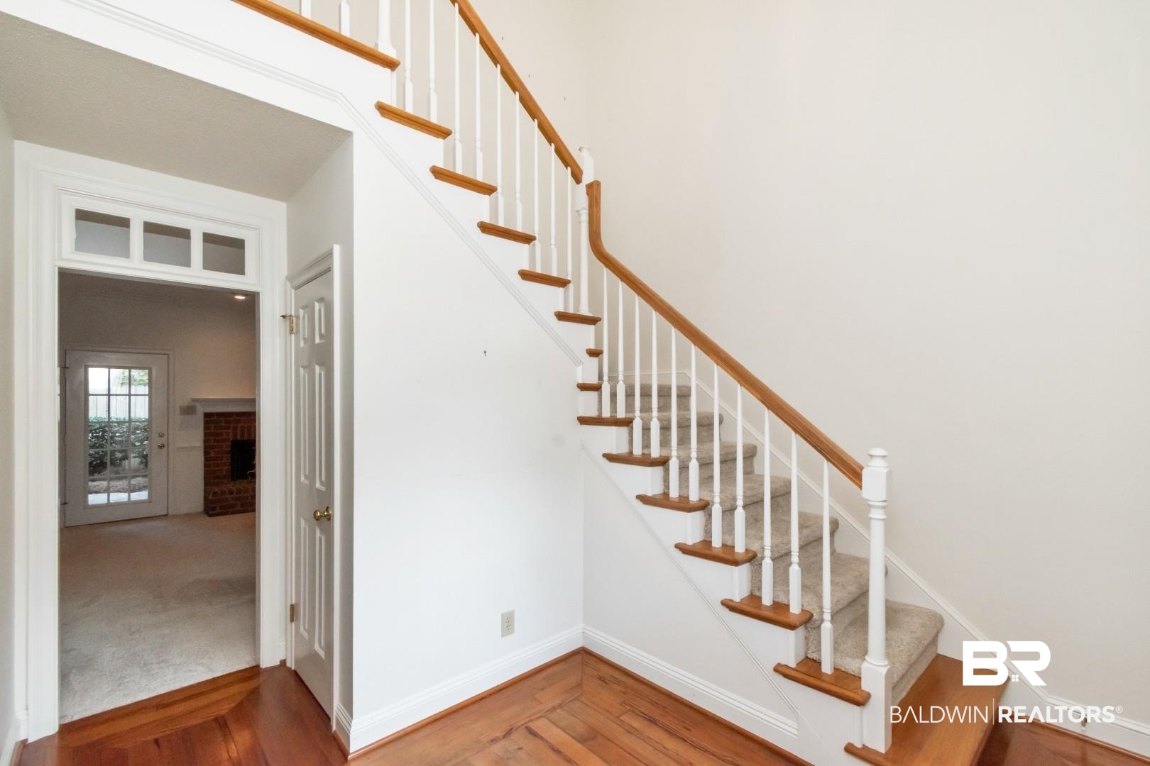 105 McHugh Lane Mobile, AL 36608 - Photo 16 of 30 Staircase with wood finished floors and a brick fireplace