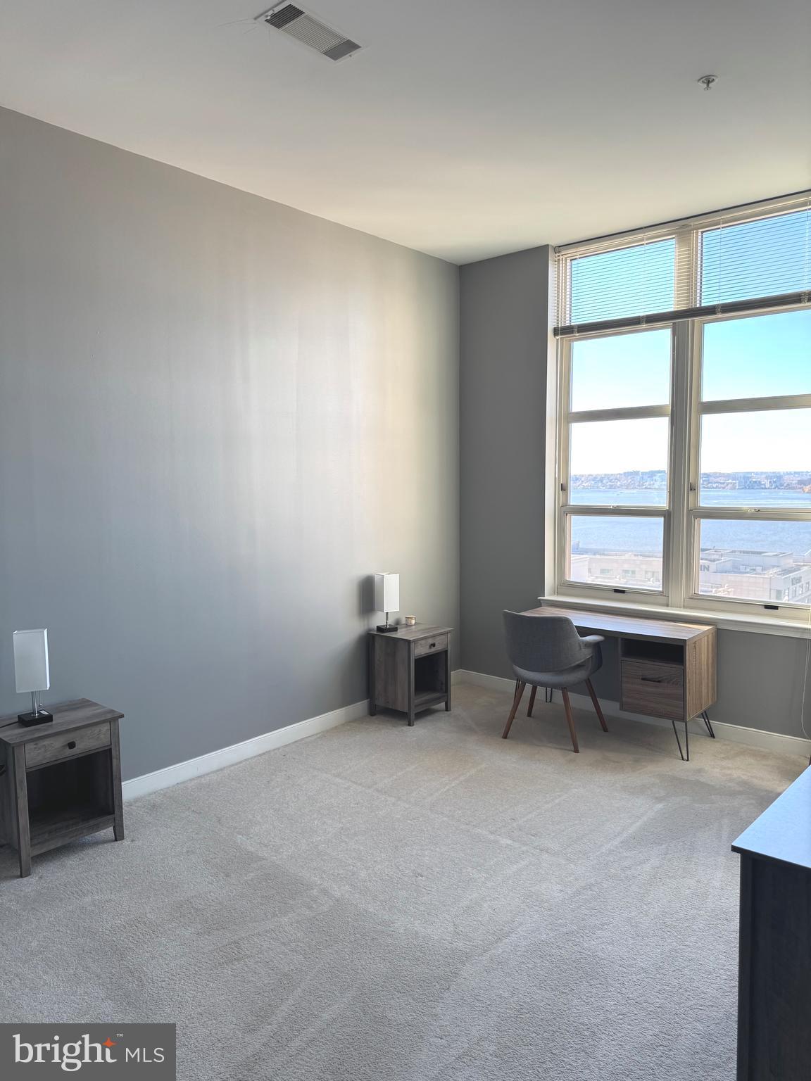 157 Fleet Street, Unit PH14 Oxon Hill, MD 20745 - Photo 12 of 27 an empty room with furniture and a window