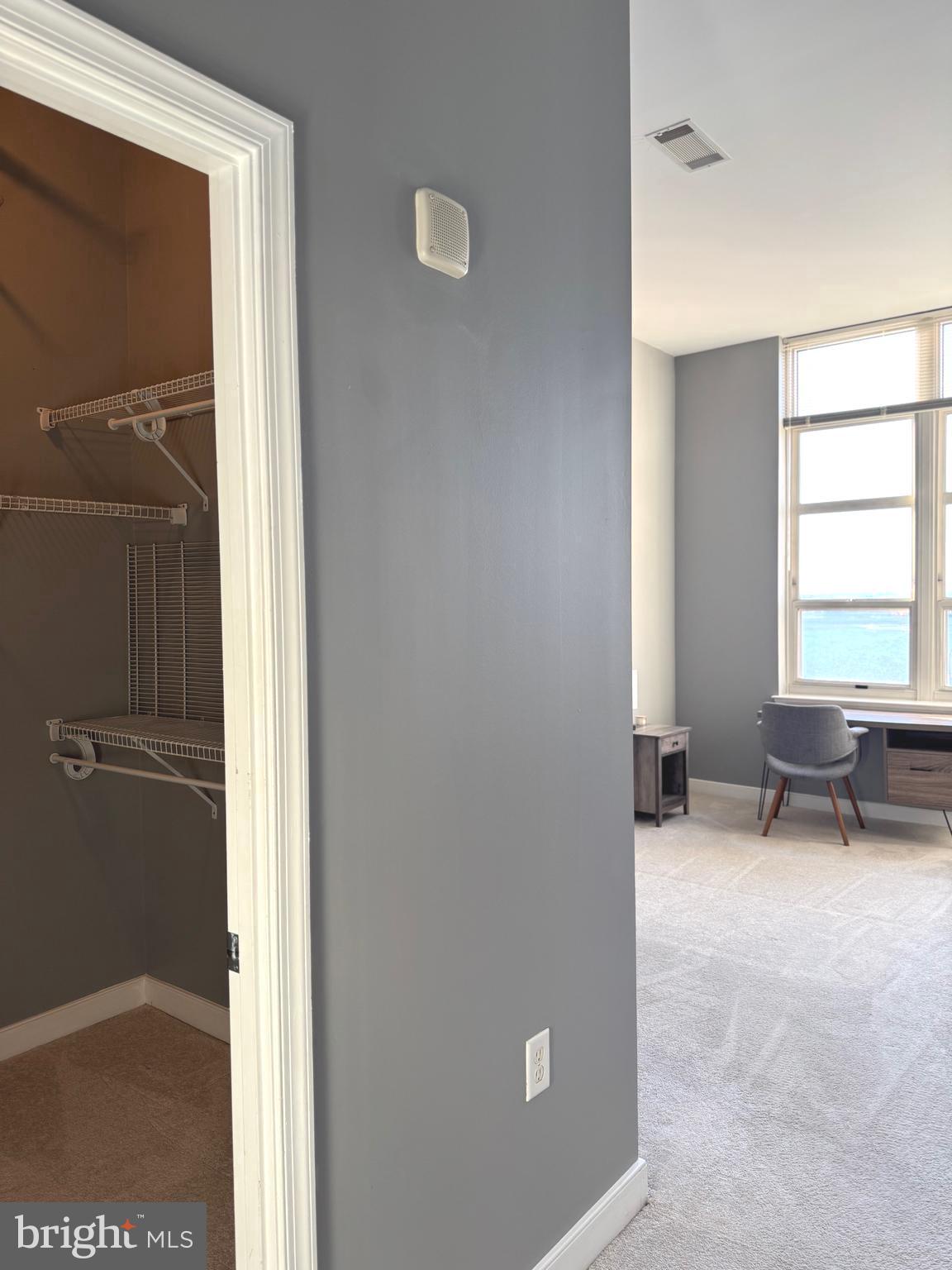 157 Fleet Street, Unit PH14 Oxon Hill, MD 20745 - Photo 13 of 27 a view of a livingroom with a chair and a window