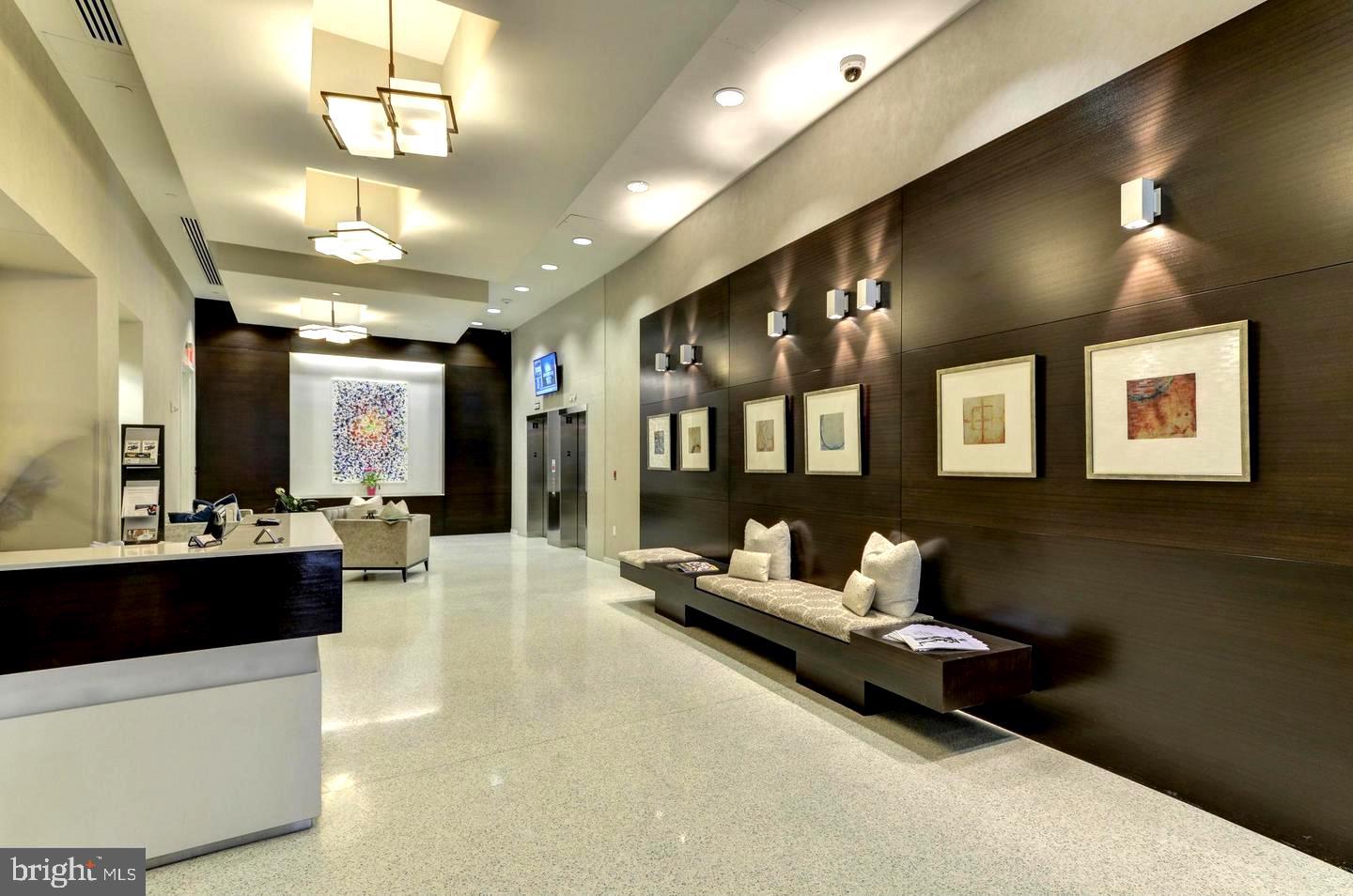 157 Fleet Street, Unit PH14 Oxon Hill, MD 20745 - Photo 17 of 27 a living room with furniture and chandelier