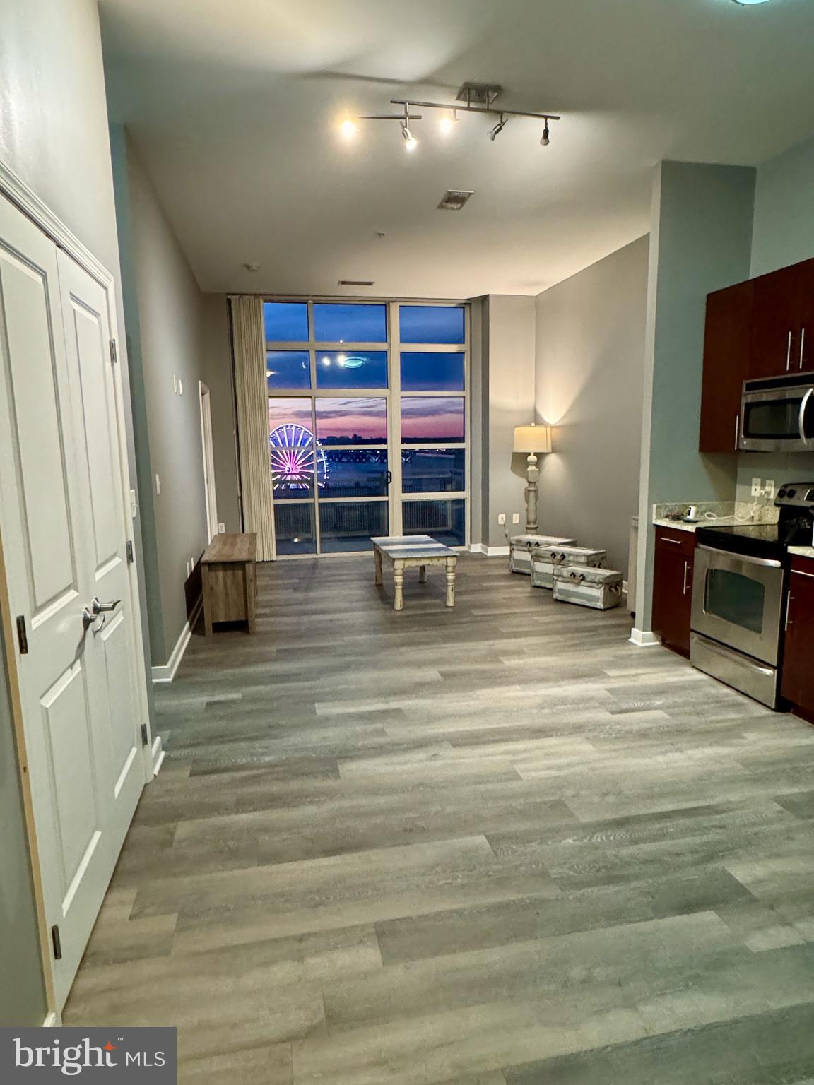 157 Fleet Street, Unit PH14 Oxon Hill, MD 20745 - Photo 4 of 27 a room with furniture and a flat screen tv