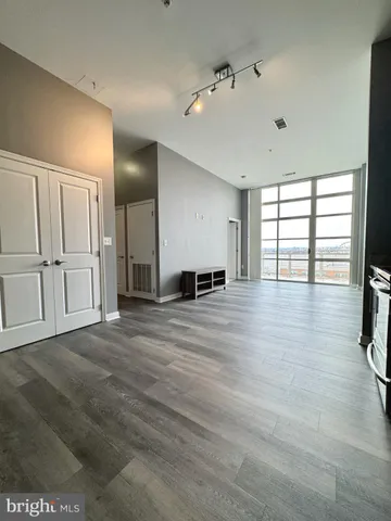 a large kitchen with stainless steel appliances granite countertop a stove and a refrigerator