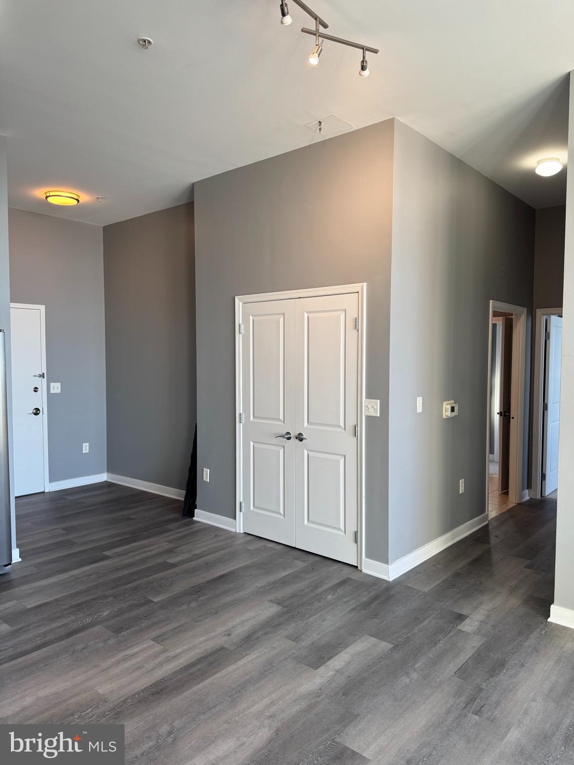 157 Fleet Street, Unit PH14 Oxon Hill, MD 20745 - Photo 7 of 27 wooden floor in an empty room with a window
