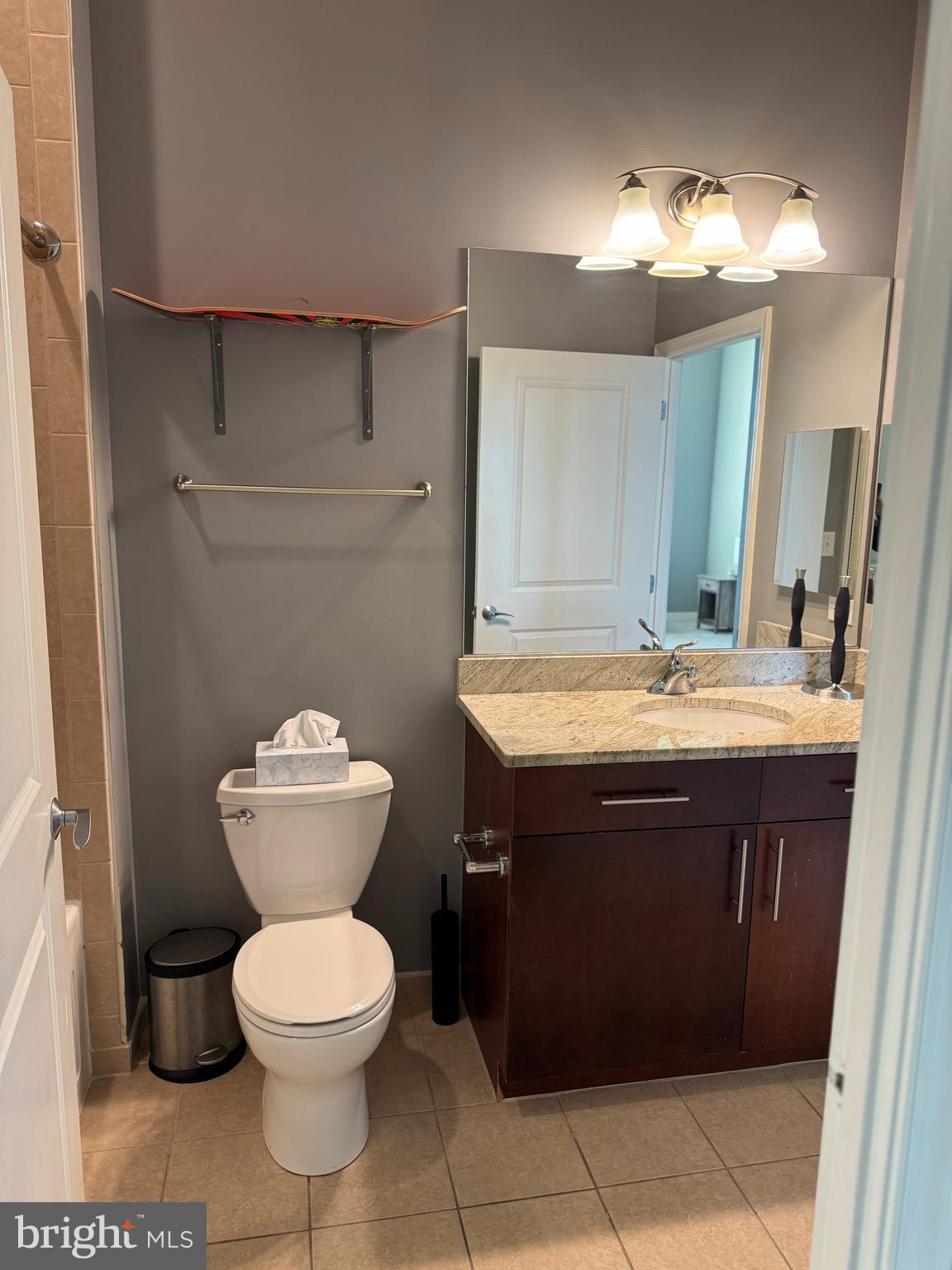 157 Fleet Street, Unit PH14 Oxon Hill, MD 20745 - Photo 9 of 27 a bathroom with a sink toilet and a mirror