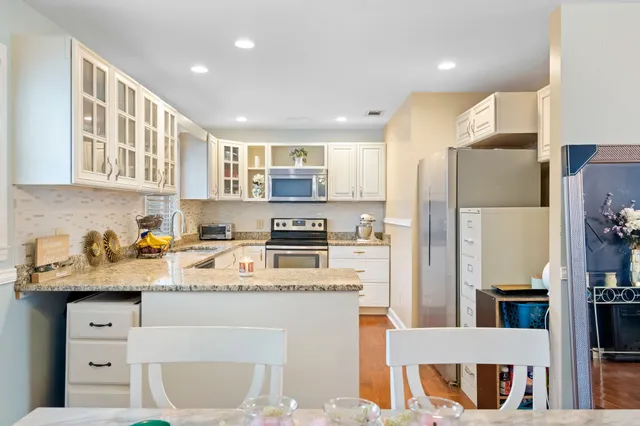 a kitchen with a sink a refrigerator a stove and cabinets