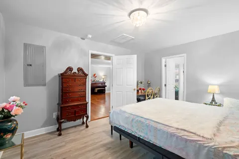a bedroom with a bed and wooden floor