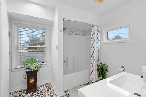 a bathroom with a sink toilet vanity and tub