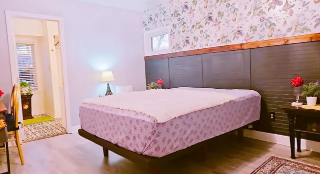 a bedroom with a bed and a potted plant