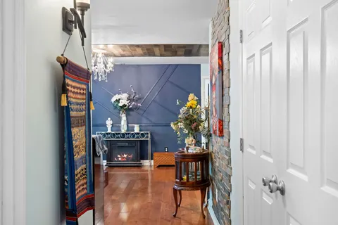 a view of a room with wooden floor and furniture