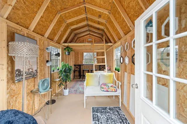 a view of an entryway with a floor to ceiling window and potted plants