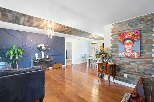 a living room with furniture and flowers