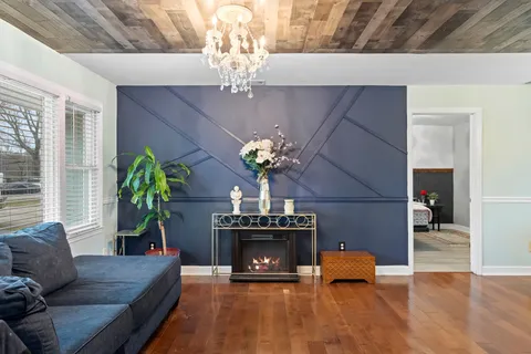a living room with furniture and a chandelier