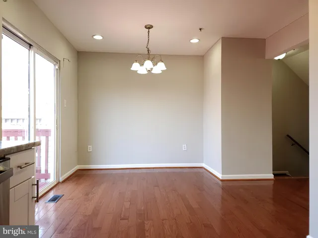 a view of livingroom with chandelier fan and wooden floor