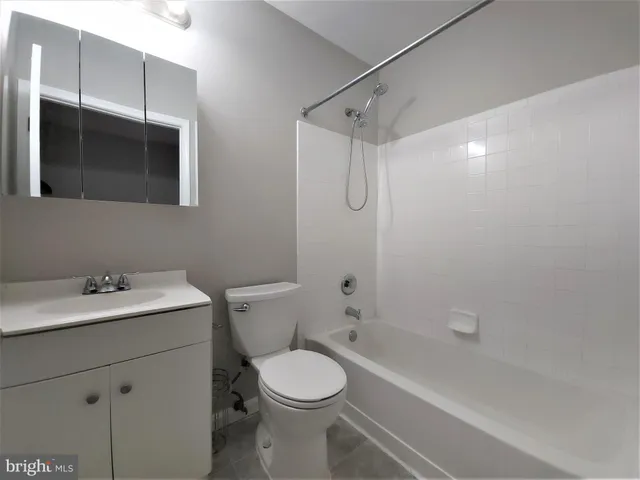 a bathroom with a toilet a sink and bathtub