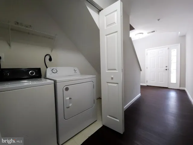 a view of washer and dryer with wooden floor