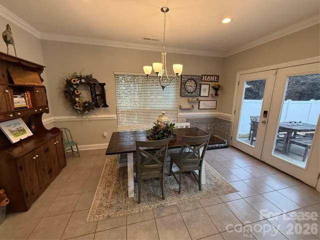 a view of a dining room with furniture and chandelier