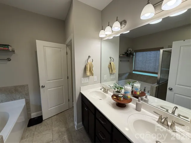 a bathroom with a sink double vanity and a mirror