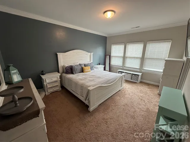 a bedroom with a bed and a chair