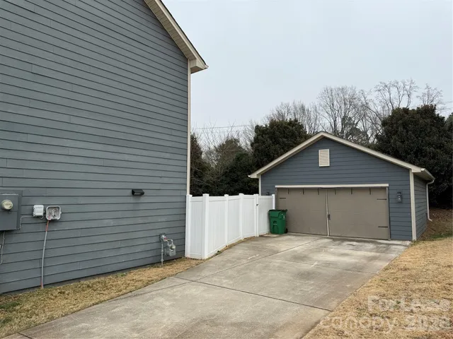 a view of a house with a yard and garage