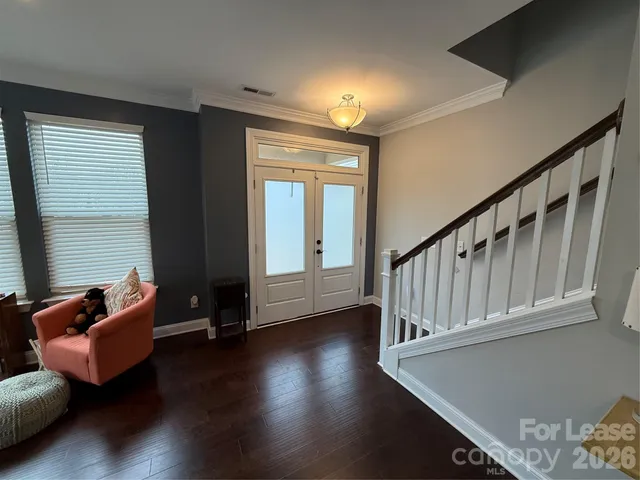 a view of room with furniture and wooden floor