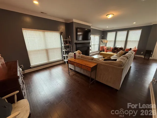 a living room with furniture window and a wooden floor