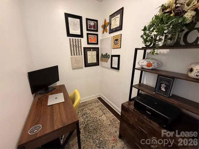 a view of workspace with lounge chair and book shelf