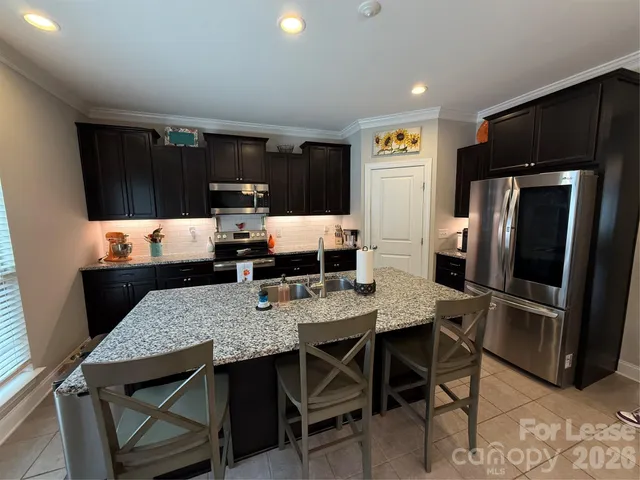 a outdoor dining space with furniture and kitchen view