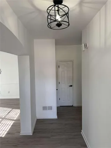 a view of a room with wooden floor