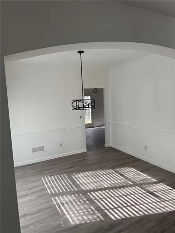 a view of a room with wooden floor