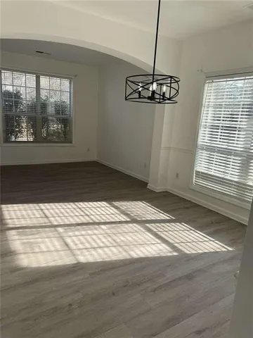 a view of a room with wooden floor and window