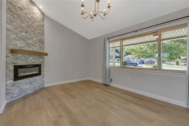 a view of empty room with windows and fireplace