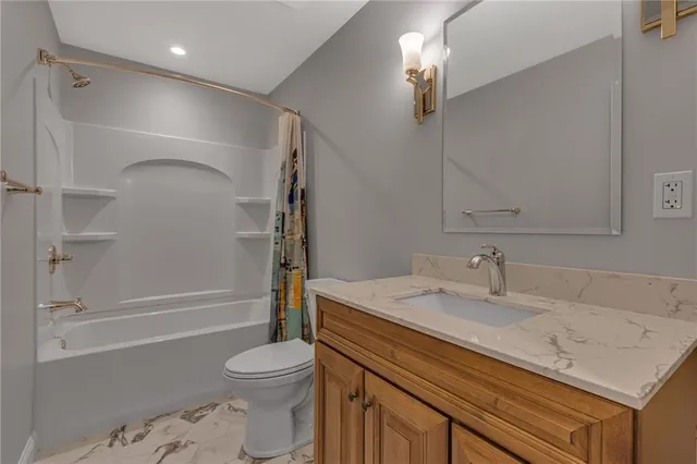 a bathroom with a sink toilet vanity and shower