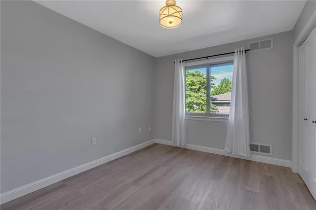 a view of room with window and hardwood floor