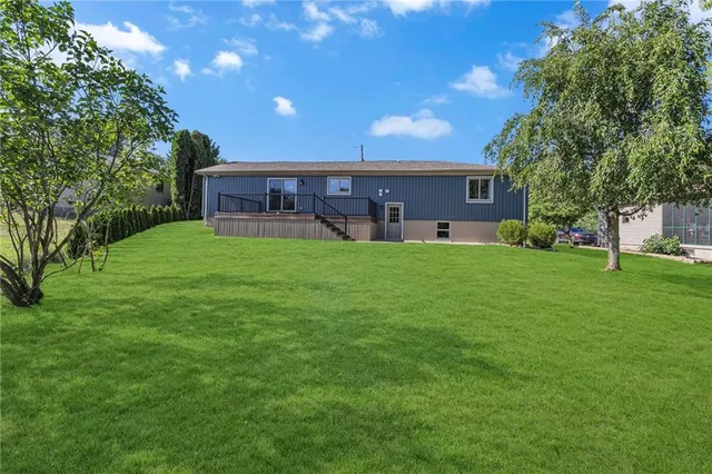 an empty room with window and stairs