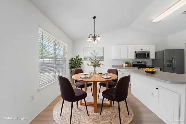 an empty room with windows and ceiling fan