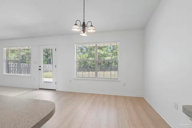 a kitchen with a sink stove top oven and refrigerator