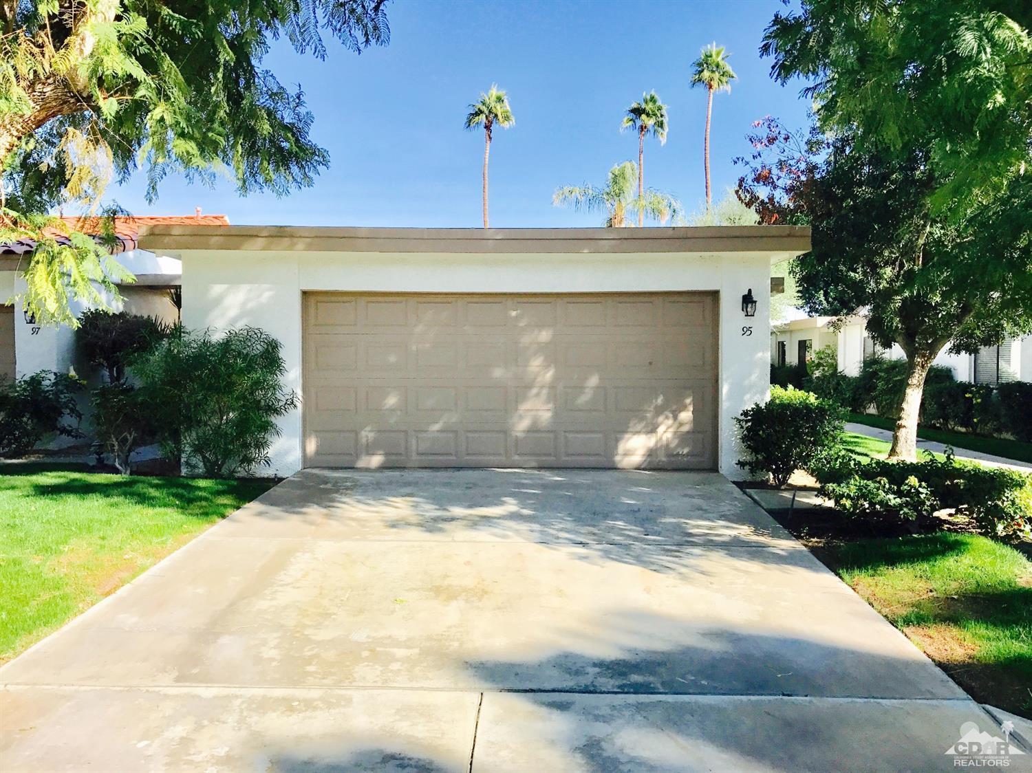 95 Calle Encinitas Rancho Mirage, CA 92270 - Photo 1 of 9 a front view of a house with a yard and a garage