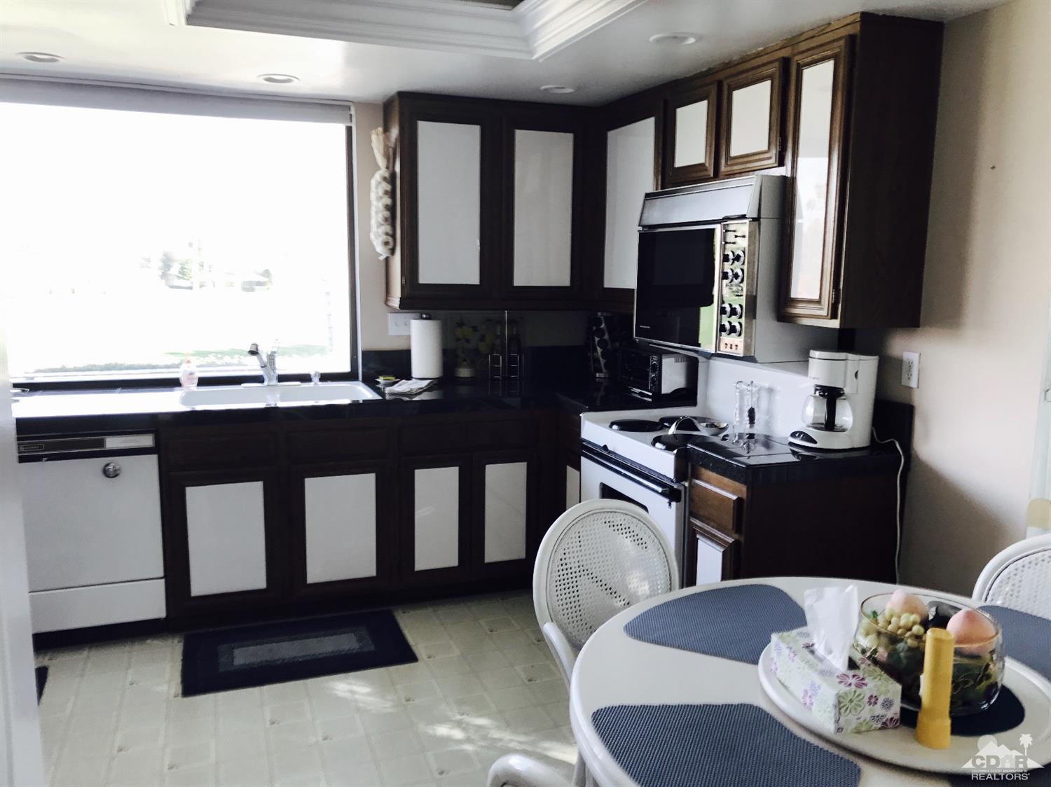 95 Calle Encinitas Rancho Mirage, CA 92270 - Photo 4 of 9 a kitchen with a sink stove and microwave