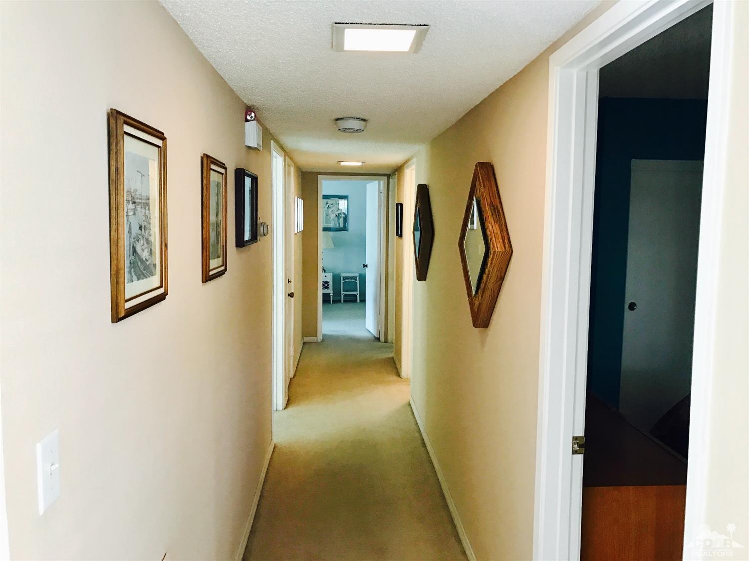 95 Calle Encinitas Rancho Mirage, CA 92270 - Photo 5 of 9 a view of a hallway with windows