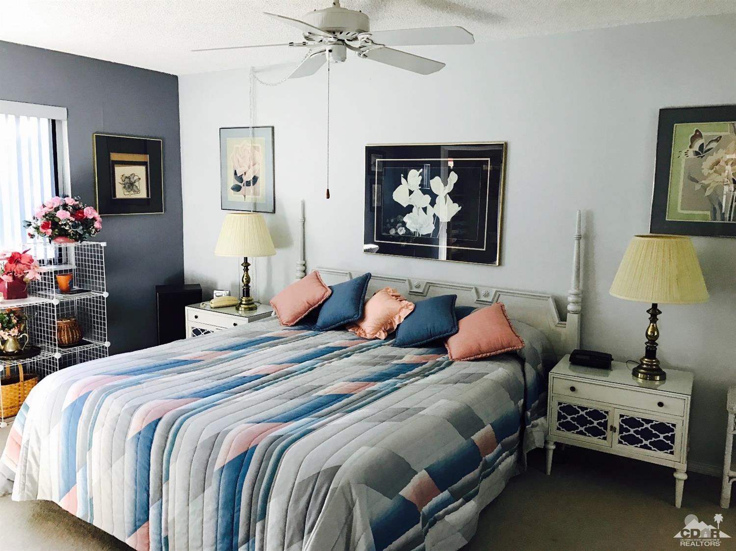 95 Calle Encinitas Rancho Mirage, CA 92270 - Photo 9 of 9 a bedroom with bed and a chandelier